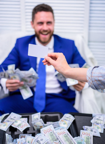 Excited successful businessman opened a box with money and rejoices in profits. Rich person. Business, people, success and fortune concept. - Фото, зображення