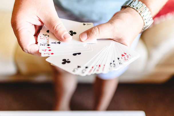 Magician hands doing magic trick with playing cards. - Photo, Image