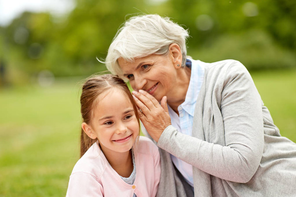 granddaughter sharing secrets with grandmother - Фото, зображення