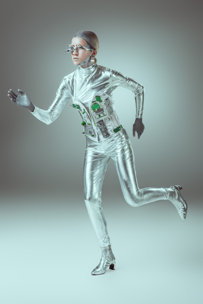 full length view of silver woman robot running on grey, future technology concept   - Foto, Imagem