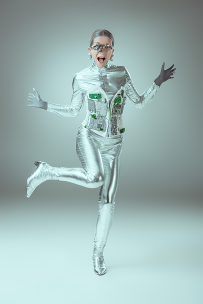 full length view of silver woman robot screaming on grey, future technology concept - Foto, Imagem