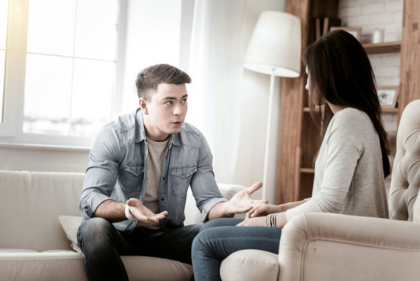 Serious young man talking to his partner - Foto, Bild