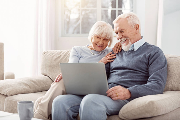 Beautiful elderly lady enjoying nice pictures with her husband - Valokuva, kuva
