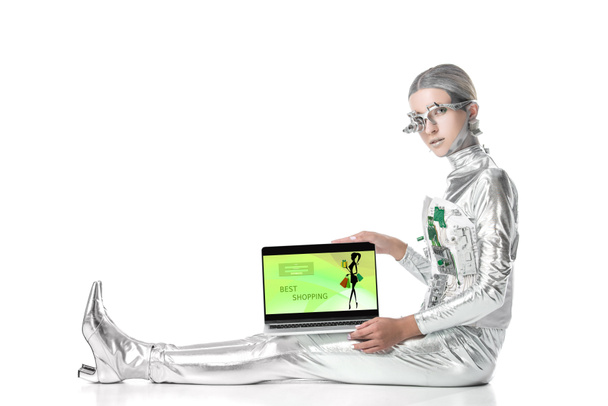 oturma ve izole beyaz, geleceğin teknoloji kavramı üzerinde cihaz alışveriş en iyi ile dizüstü bilgisayarı gösteren gümüş robot - Fotoğraf, Görsel