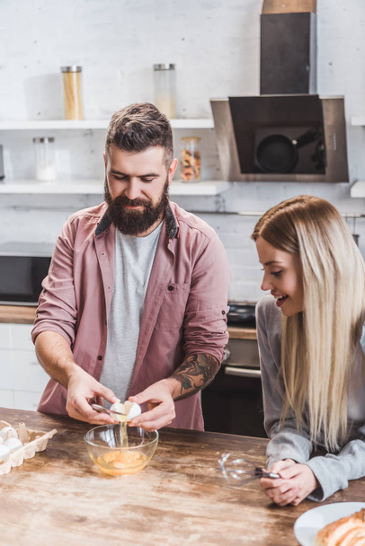 young couple preparing breakfast together at kitchen - Photo, image