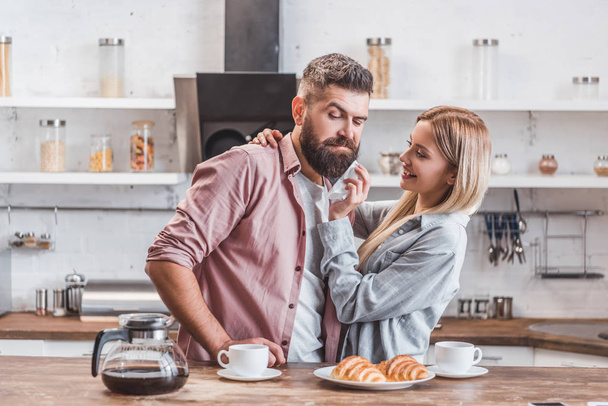 attractive young couple having breakfast together at kitchen - Photo, image