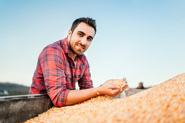 Portrait of farmer with corn, smiling man harvesting - Fotoğraf, Görsel