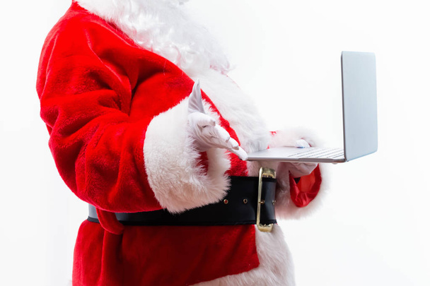 Santa using a laptop - Фото, изображение