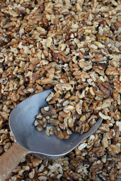 Scoop with shelled walnuts. Fresh nuts snack food background. - Photo, Image