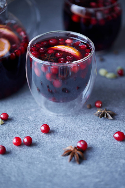 homemade mulled wine with cranberries on grey tabletop in kitchen - Photo, image