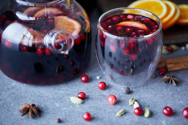 delicious homemade mulled wine with cranberries on table in kitchen - Fotografie, Obrázek