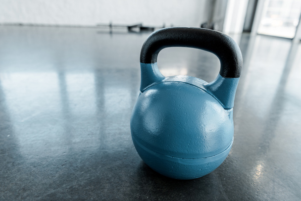 large blue kettlebell on gym floor with copy space - Photo, Image