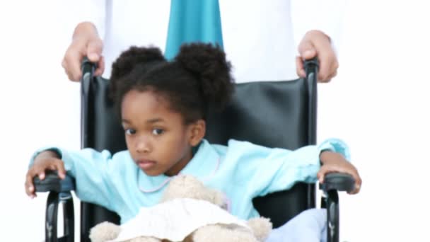 Portrait of ethnic little girl sitting on wheelchair - Metraje, vídeo