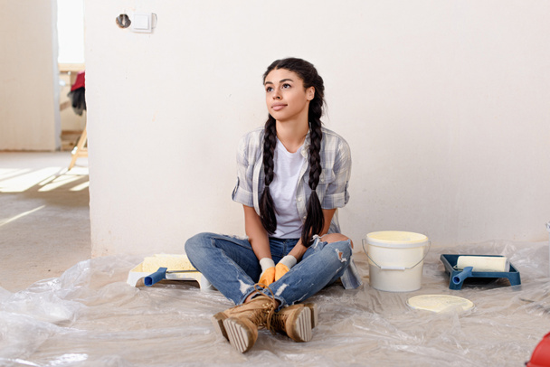thoughtful young woman looking away during renovation of new home - Photo, Image