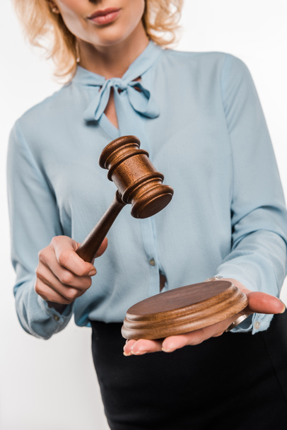 cropped shot of female judge holding wooden hammer isolated on white   - Photo, Image
