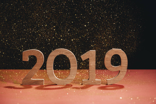 wooden number 2019 Happy New Year on dark glitter background - Photo, Image