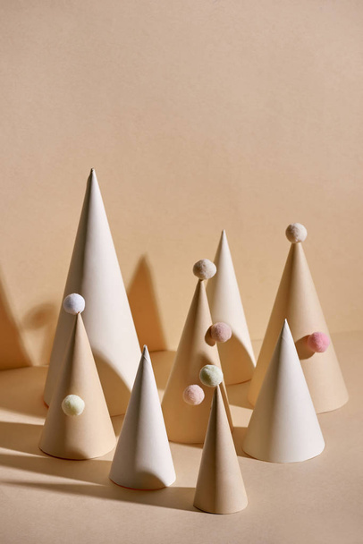 Creative Christmas trees made of paper on beige background - Foto, Imagen