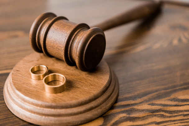 vista close-up de martelo de madeira e anéis de casamento na mesa, conceito de divórcio
 - Foto, Imagem