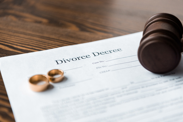 close-up view of divorce decree, wedding rings and wooden hammer - Photo, Image