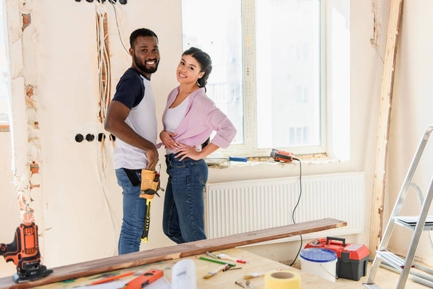 selective focus of happy african american couple posing during renovation of new home - Photo, Image
