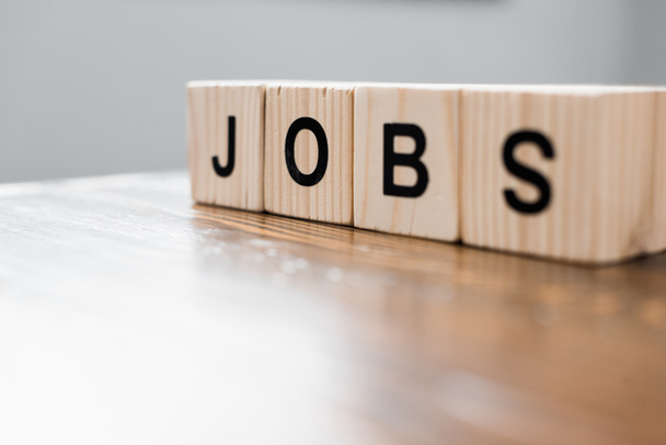 close-up shot of wooden blocks with JOBS sign on table - Photo, Image