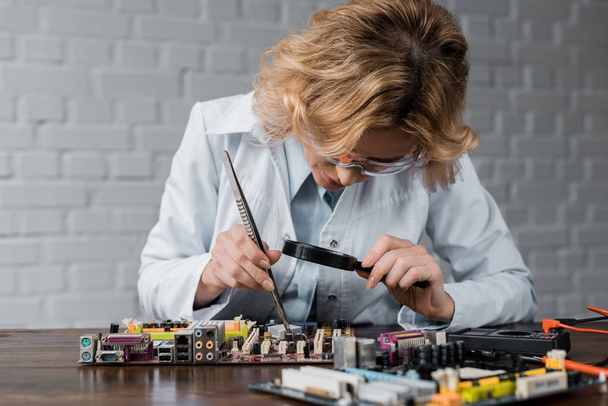 concentrated female computer engineer repairing motherboard - Photo, Image