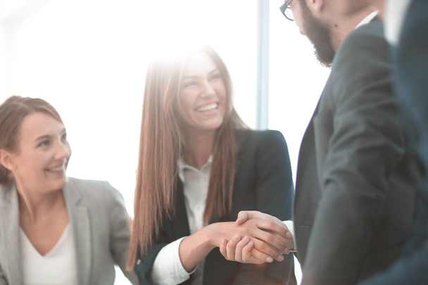 close up.smiling business woman shaking hands with partners - Photo, image