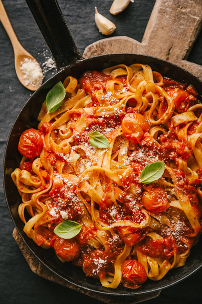 top view of Tasty appetizing spaghetti with tomato sauce and cheese on pan on table - Fotoğraf, Görsel