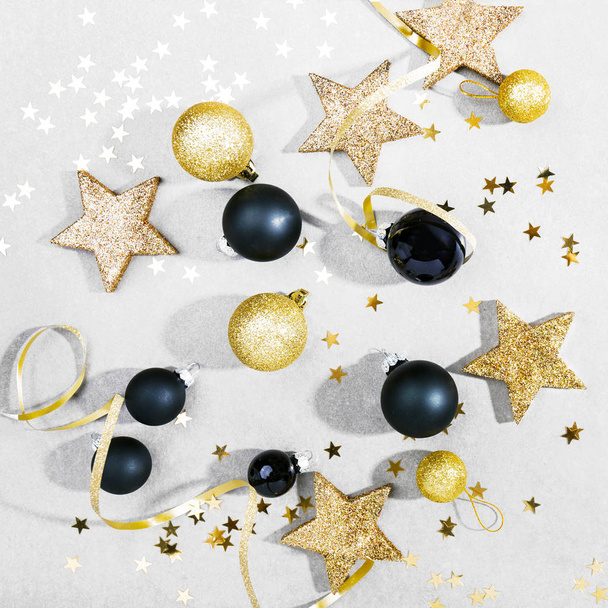 υπερυψωμένη θέα όμορφη Χριστούγεννα μαύρα, χρυσά και ασημένια διακοσμητικά στολίδια σε λευκό φόντο - Φωτογραφία, εικόνα