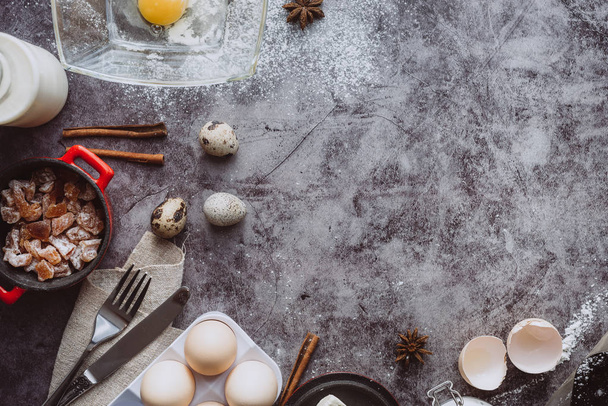 Healthy baking ingredients. Spoon with flour, dishes, eggs, butter salt and rolling pin on a grey background.Bakery background frame. Top view, copy space. - Φωτογραφία, εικόνα