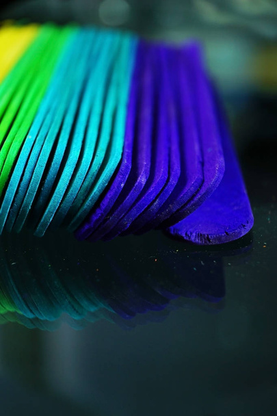 colorful wooden sticks on dark background, close-up  - Фото, зображення