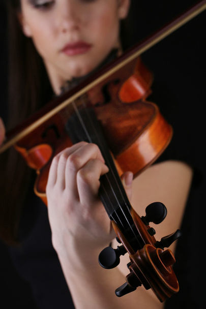 Musician playing violin on black background - Photo, image