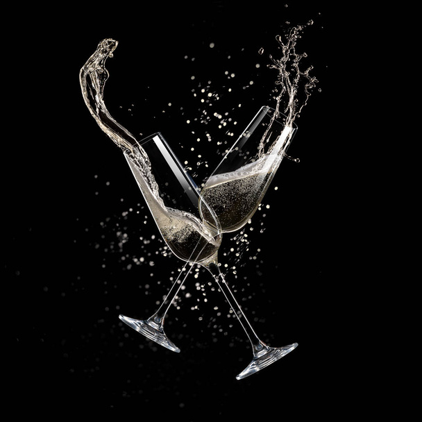 Glasses of champagne levitating in the air, celebration theme. - Фото, зображення