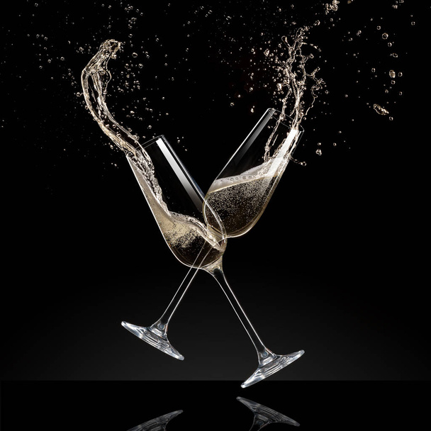 Glasses of champagne levitating in the air, celebration theme. - Фото, изображение