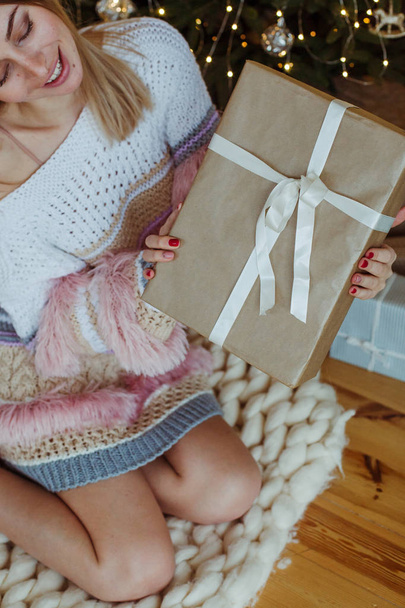 Excited  woman opening christmas gift box at home - Foto, Bild