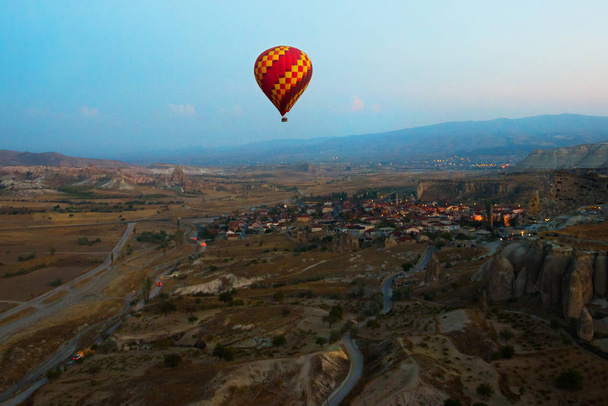 Cappadocia, Turkey: Balloon against the blue sky in flight, colorful fun entertaining form of transport, flight in the air of the balloon, the concept of dream and happiness - Photo, Image