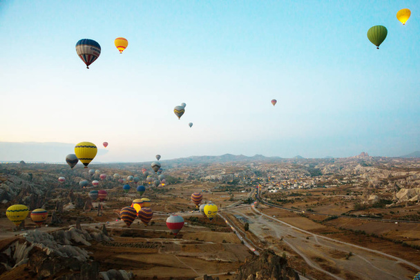 Cappadocia, Turkey: Balloon against the blue sky in flight, colorful fun entertaining form of transport, flight in the air of the balloon, the concept of dream and happiness - Foto, imagen