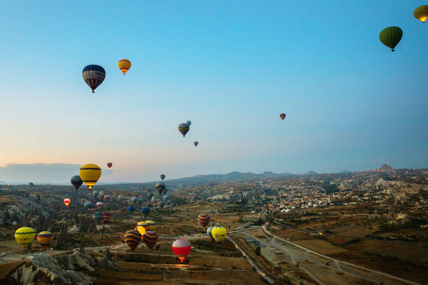 Cappadocia, Turkey: Balloon against the blue sky in flight, colorful fun entertaining form of transport, flight in the air of the balloon, the concept of dream and happiness - Fotografie, Obrázek