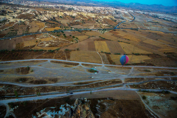 Cappadocia, Turkey : Hot Air Balloons are flying during sunrise in Cappadocia Region of Turkey. Balloon against the blue sky in flight, colorful fun entertaining form of transport, flight in the air of the balloon, the concept of dream and happiness - Valokuva, kuva