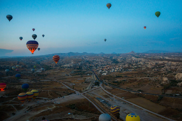 Cappadocia, Turkey : Hot Air Balloons are flying during sunrise in Cappadocia Region of Turkey. Balloon against the blue sky in flight, colorful fun entertaining form of transport, flight in the air of the balloon, the concept of dream and happiness - Foto, imagen