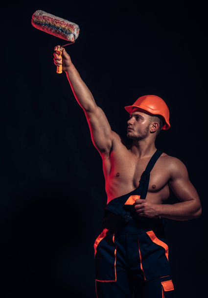 Make your painting projects go faster and smoother.Construction worker or builder. Skilled painter or decorator man. Muscular man at painting work. Worker hold brush roller in muscular hands - Foto, Imagen