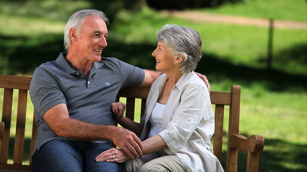 Senior couple talking together on a bench - Filmmaterial, Video