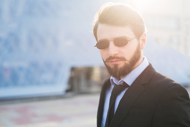 Portrait of bearded hipster on skyscraper background. - Фото, зображення