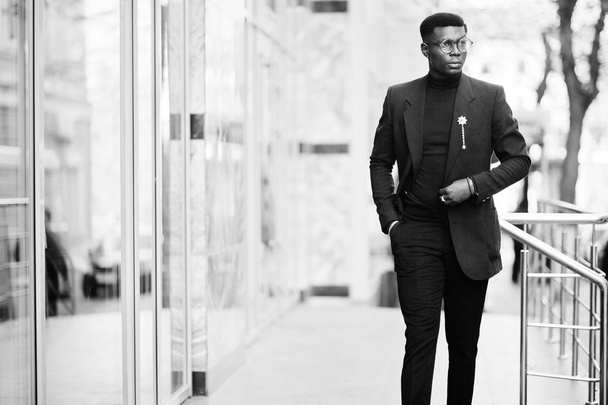 Amazingly looking african american man wear at blue blazer with brooch, black turtleneck and glasses posed at street. Fashionable black guy. - Valokuva, kuva