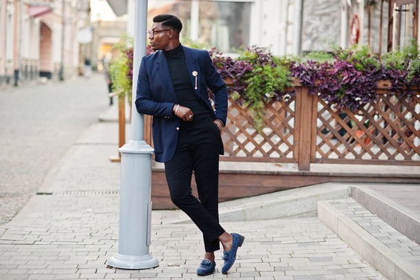 Amazingly looking african american man wear at blue blazer with brooch, black turtleneck and glasses posed at street. Fashionable black guy. - Fotó, kép