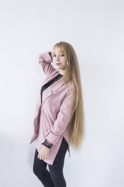 Beautiful female model. girl with long blond hair in a pink jacket - Foto, Imagem