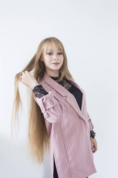 Beautiful female model. girl with long blond hair in a pink jacket - Fotografie, Obrázek