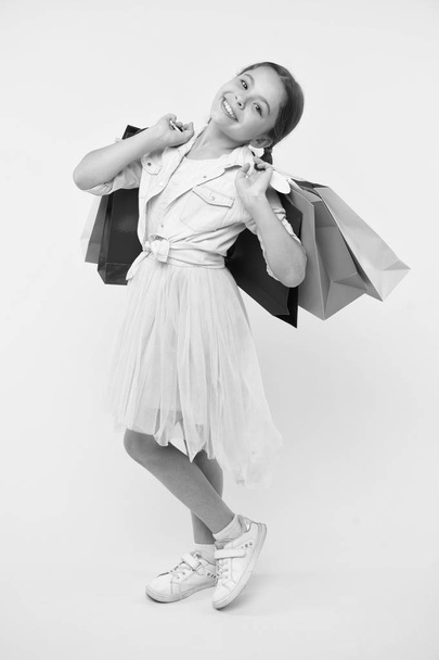 kid in shop. happy kid in shop with bags. beautiful little kid girl in shop. kid shop concept. shopping is the best therapy. - 写真・画像