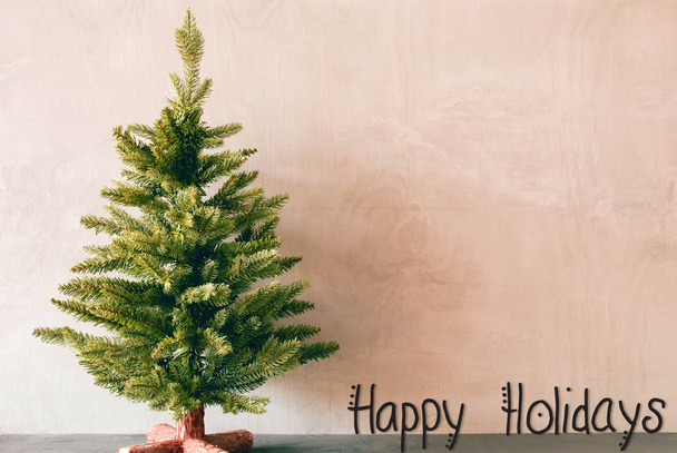 Πράσινο δέντρο, καλλιγραφία Happy Holidays, φόντο ροζ τσιμέντου - Φωτογραφία, εικόνα