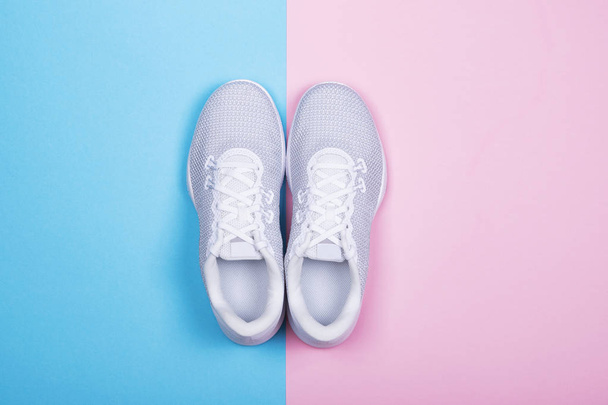 White sneakers on blue and pink background.  - Photo, Image